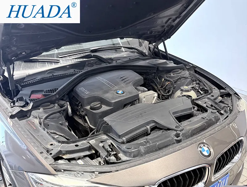 BMW 轿车在4S店打开发动机盖进行检修,发动机舱内部可见使用耐高温尼龙扎带固定线束和管路的区域